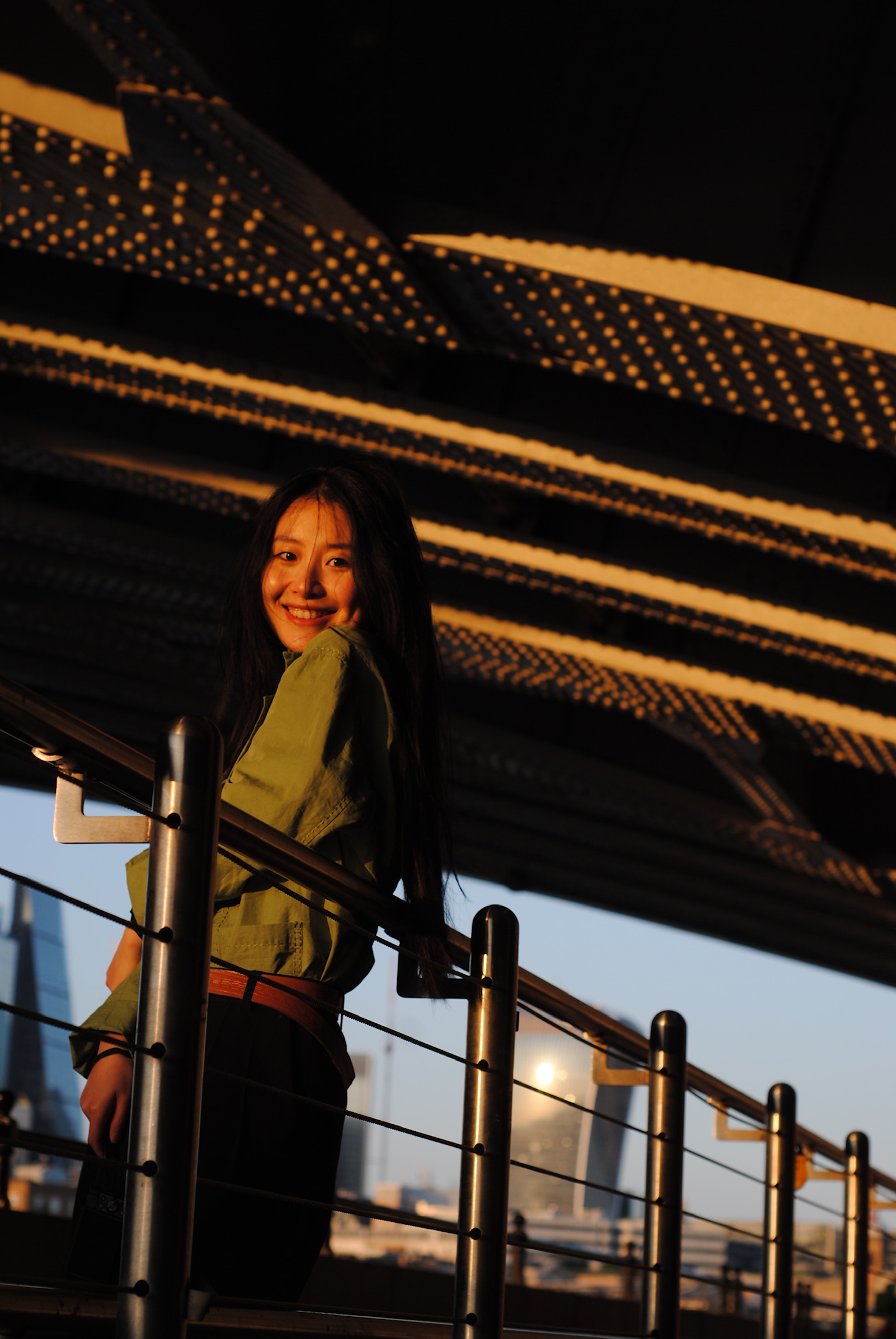 Woman on modern staircase at golden hour