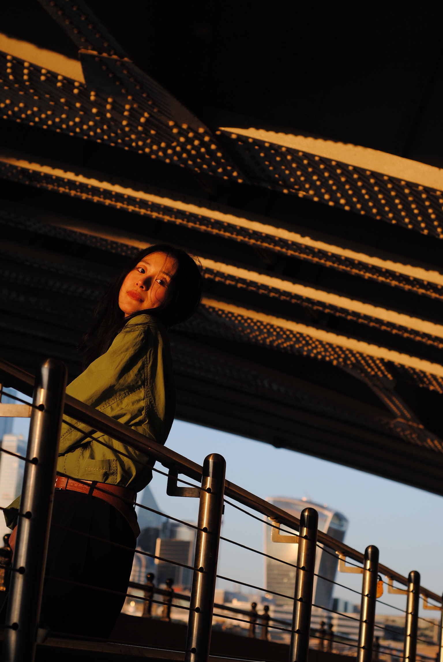 Woman beneath modern canopy at golden hour