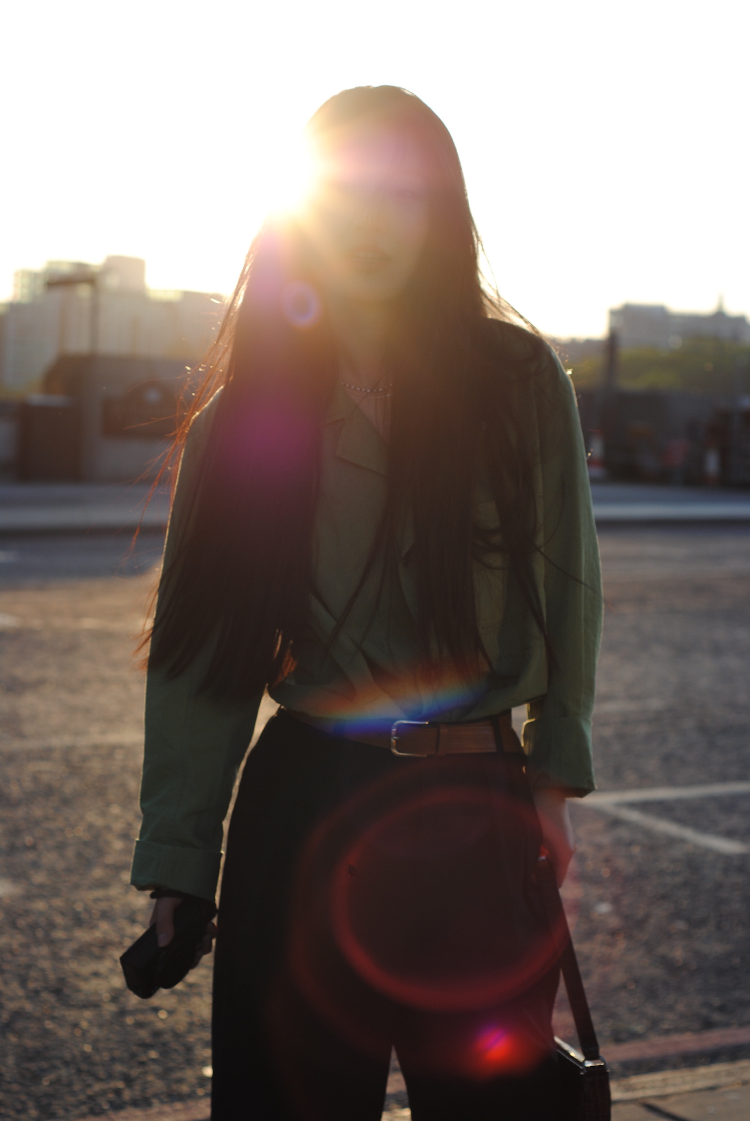Woman on rooftop with dramatic backlight flare