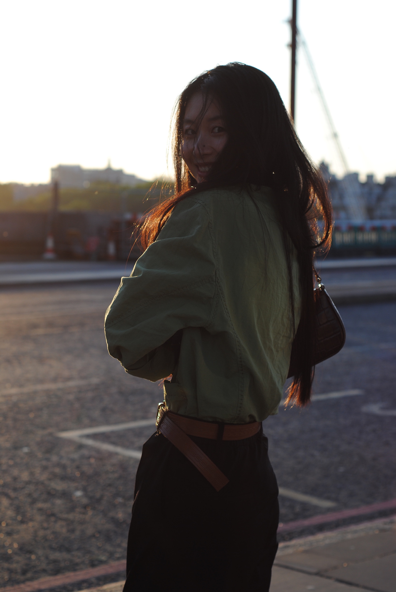 Woman turning back with gentle smile at golden hour