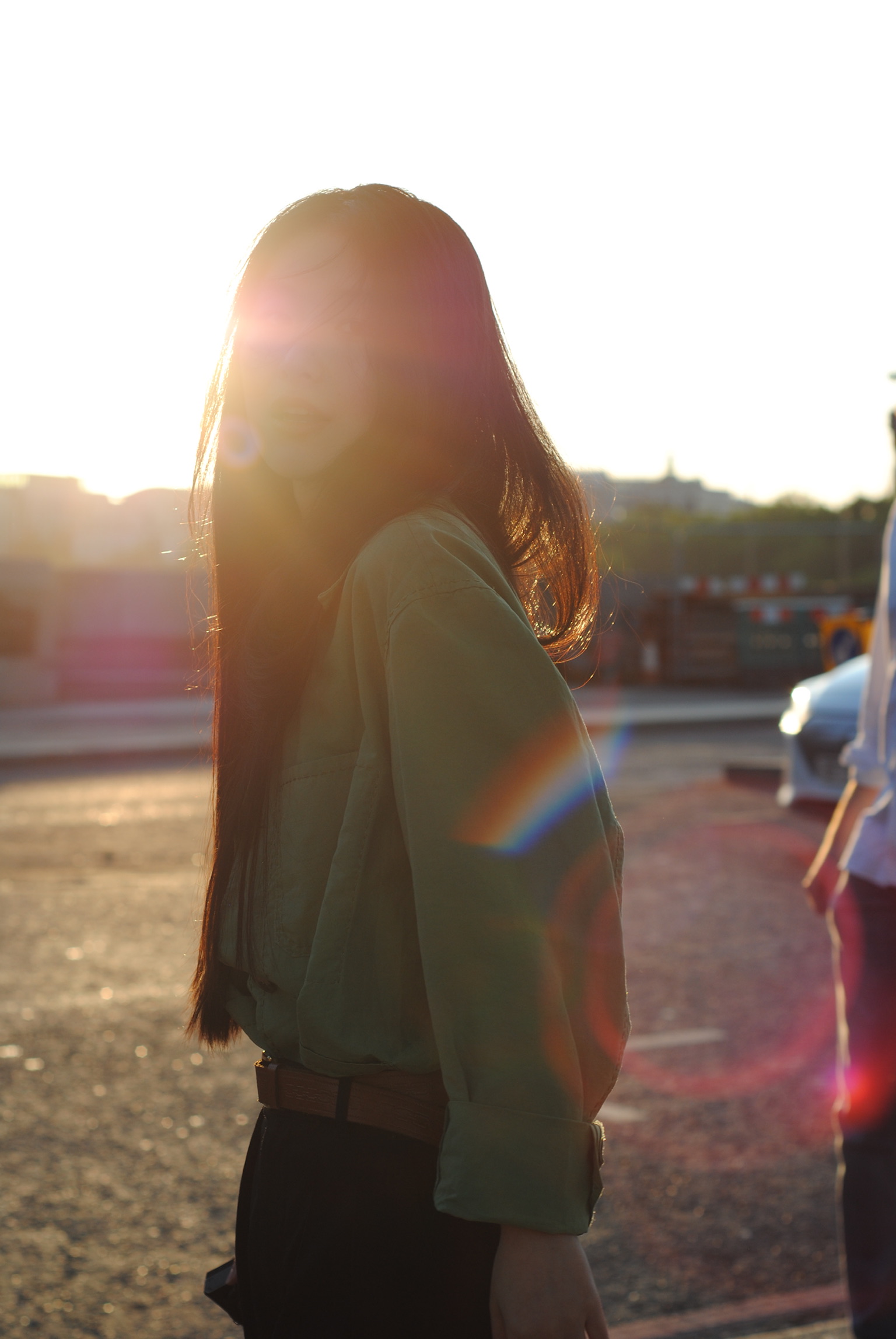 Backlit portrait with golden lens flare at sunset